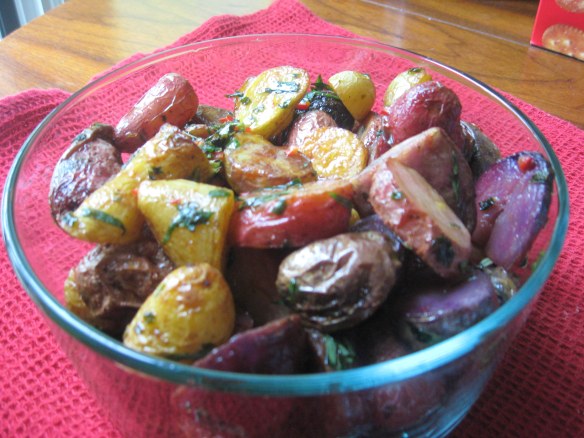 ready to go IMG_6940 roasted potatoes, with herbs and chili peppers in serving dish.